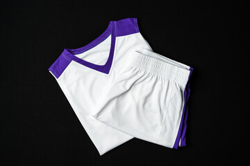 White and Purple Athletic Tank Top Laid Flat on Black Background