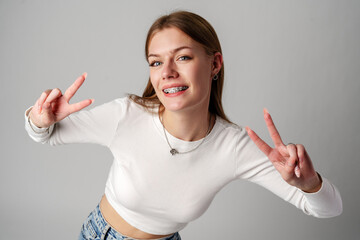 Young Woman Making Peace Sign With Hands in studio