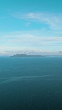 Tropical islands in the blue sea against the background of the sky and clouds. Philippines.