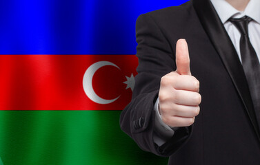 Azerbaijani concept. Businessman showing thumb up on the background of flag of Azerbaijan - 793648515
