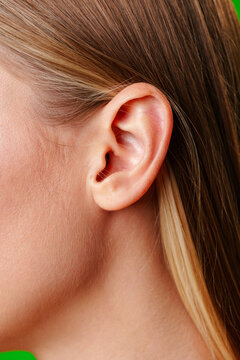 Womans Ear Close Up With Green Background