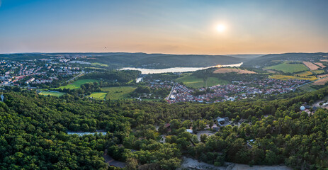 Panoramic aerial shot of Brno with dam and forests during sunrise