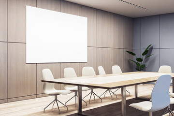 A modern conference room with empty chairs, a wooden table, and a large blank whiteboard on the...