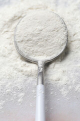 White powder in the spoon. Collagen protein powder or wheat flour. Concept of nutritional supplement, dieting, detox, preventive healthcare and healthy lifestyle.	