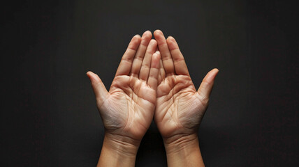 hands praying on black background