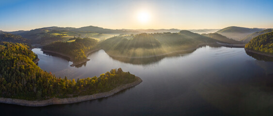 Dreamy view of Vír dam during sunrise in the autumn