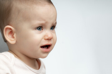 Portrait of sad and upset toddler baby because of being hungry and tired - obrazy, fototapety, plakaty