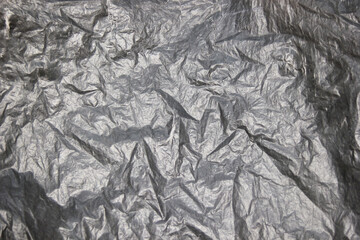 Crumpled aluminum foil texture as background
