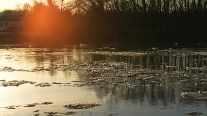 ice melts river sunset current, glowing evening ripples, riverside sunset atmosphere, sunset...