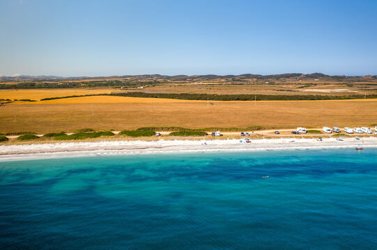 Pazzona wild beach aerial drone view full with camper vans in Sardinia