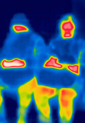 A group of young people. Everyone is busy with their smartphone.Image from thermal imager device.