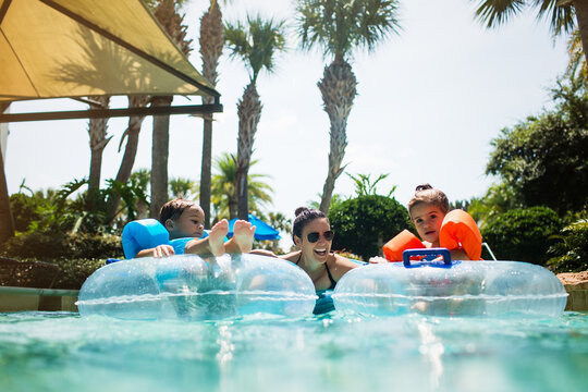Family fun with kids on inflatables in a lazy river