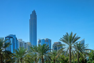 Fototapeta na wymiar Abu Dhabi, Arab Emirates - February 16, 2023: Modern urban architecture of the business part of the city. Dominated by high-rise buildings. An example of urban greening, landscaping of cities