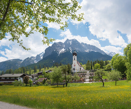 Landscape village church and cemetery Obergrainau, Wetterstein Mountains in spring