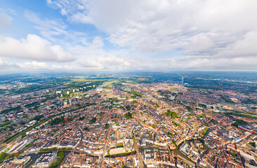Ghent, Belgium. City center and surroundings. Residential and industrial areas. Panorama of the city. Summer day, cloudy weather. Aerial view