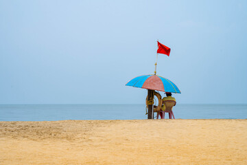 person with umbrella on the beach