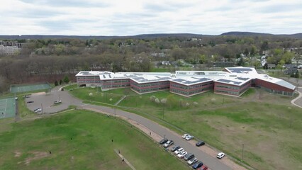 Drone footage of Middle school located in Hamden, Connecticut. overlooking people playing cricket