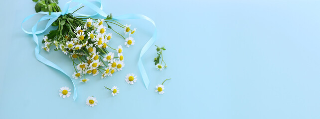 spring bouquet of daisies flowers over blue background