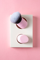 Kabuki brush and sponge blender on pink background , top view - obrazy, fototapety, plakaty