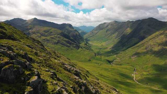 Glencoe, Scotland; Aerial revealing Red Deer and beautiful valley in the Scottish Highlands. Views of Scotland. Scottish Mountains, United Kingdom. Landscapes of Scotland.