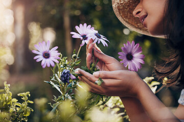 Girl, hand and smell flower in garden for floral aroma, relaxation and happiness for nursery blossom or bloom. Female florist, nature and plants for sustainability or ecology, peaceful and outdoor. - obrazy, fototapety, plakaty