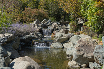 Triple waterfall in the Japanese Garden. Water falls from a height of 7 meters into artificial...