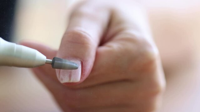 Removing shellac from the nails with fraser. Closeup. Selective focus. 4K