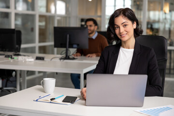 Professional woman manager operating laptop foe work in office