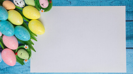 Creative easter wooden flatlay with white paper blank. Tulips and easter eggs on postcard