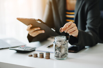 Hand putting mix coins and seed in clear bottle and business investment growth concept.