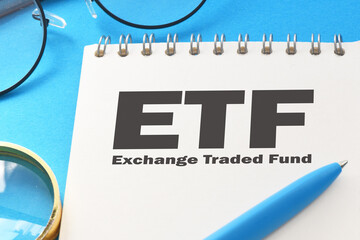 ETF - Exchange Traded Fund words in office notebook - concept.