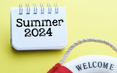 The word Summer 2024 written on a notepad.