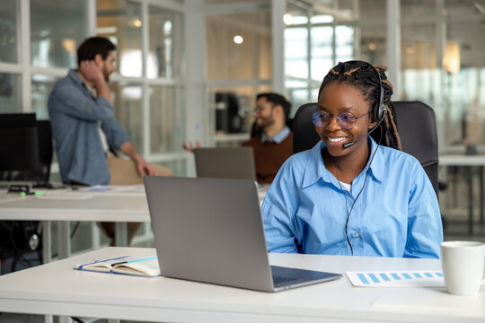 African American woman call center operator agent consulting customer wearing headset