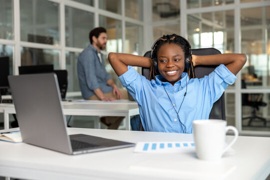 African American relaxed woman call center operator agent consulting customer wearing headset