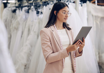Tablet, wedding dress and fashion designer woman in studio for online order or planning. Review,...