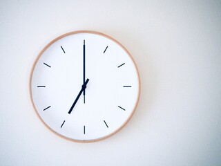 minimal clock on a wall show 7.00, 19.00