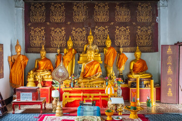 The gold Buddha statue at Wat Syrimoungkoun Xaiyaram in Luang Prabang, Laos