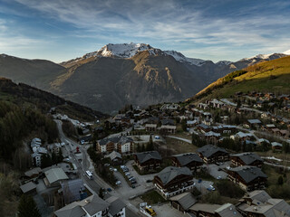 Town in the alps mountains during sunset. Aerial drone photo. French alps in winter,  Rhone Alpes...