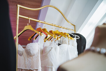 Fashion accessory row of wedding dresses hanging on rack