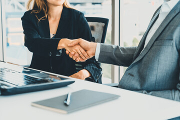 Businessman executive handshake with businesswoman worker in modern workplace office. People...