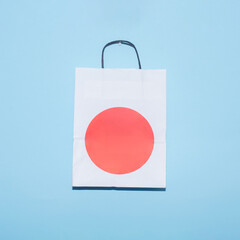 White paper bag with red circle on a blue background creative concept. 