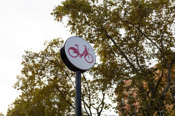 Sign indicating lane for bicycle traffic with trees in the background. Concept of transportation