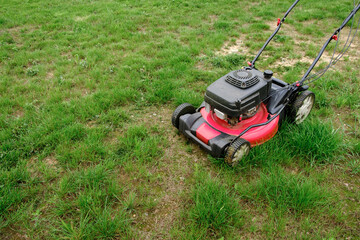 Lawn mover on green grass background. Machine for cutting lawns. Garden care. Electric equipment....