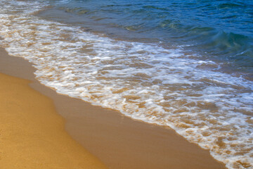Gentle waves on sandy beach