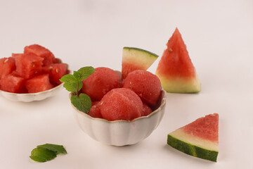 Homemade Scoops of Watermelon Sorbet in a Bowl, Garnish with Mint Leaf.
