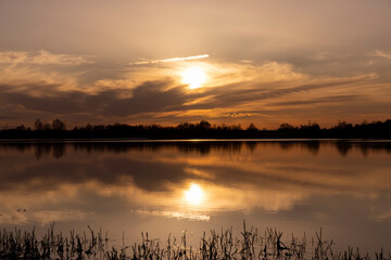 The sky and the lake are red-tinged during sunset