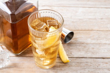 Highball, Whiskey with soda and lemon beverage on wooden table. Copy space