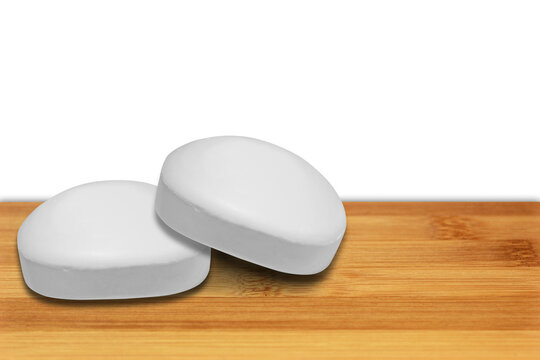 White soap bars on a wooden shelf with some empty space for editing on the right side