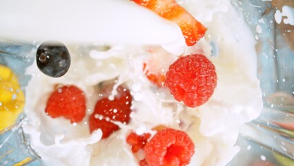 Overhead Shot of Pieces of Fruits with Milk in Blender.