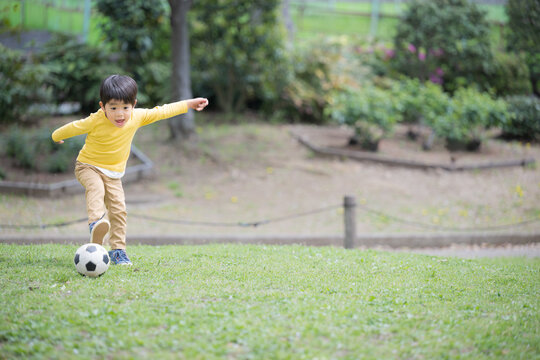 Asian (Japanese) boy playing soccer